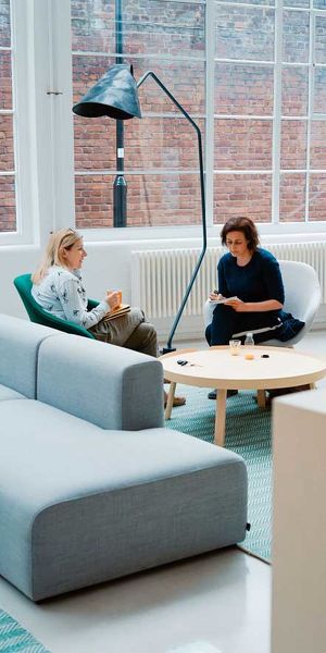 two women sitting on couch